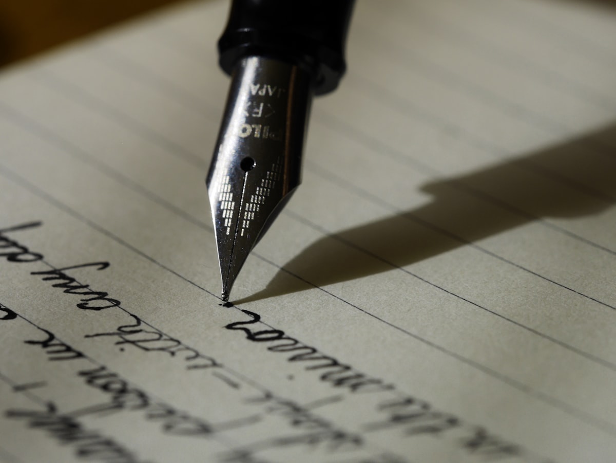 Fountain pen nib resting on a handwritten page