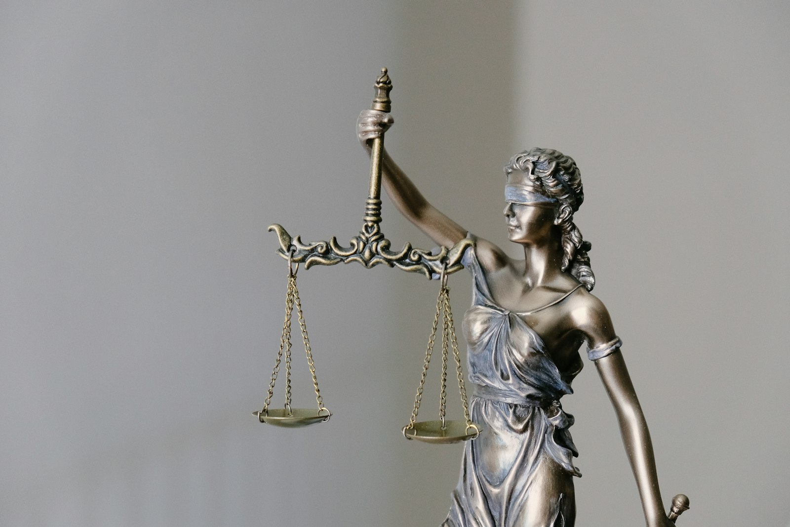 Bronze figure of Justice holding balanced scales